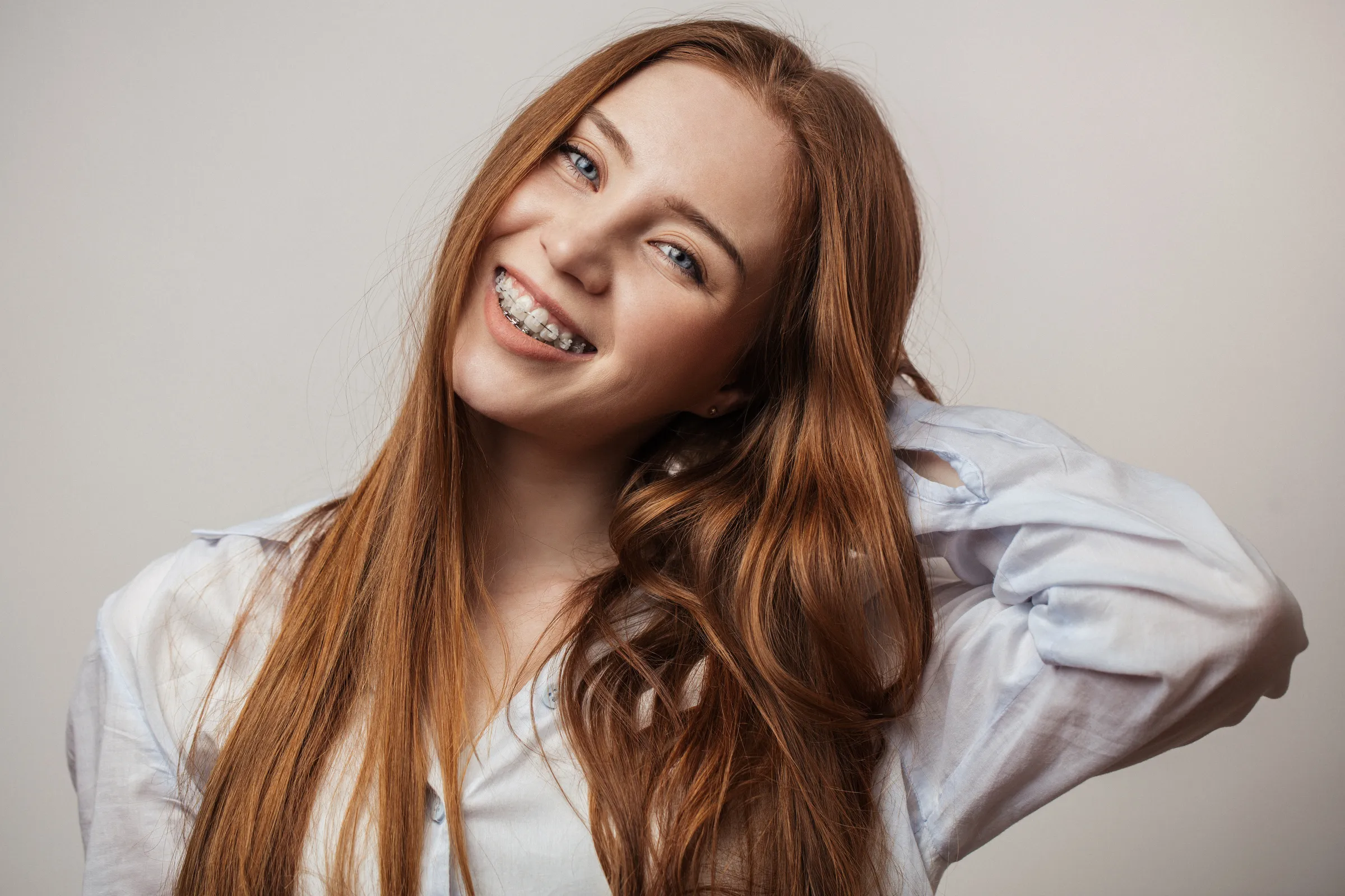 A young woman smiling with braces