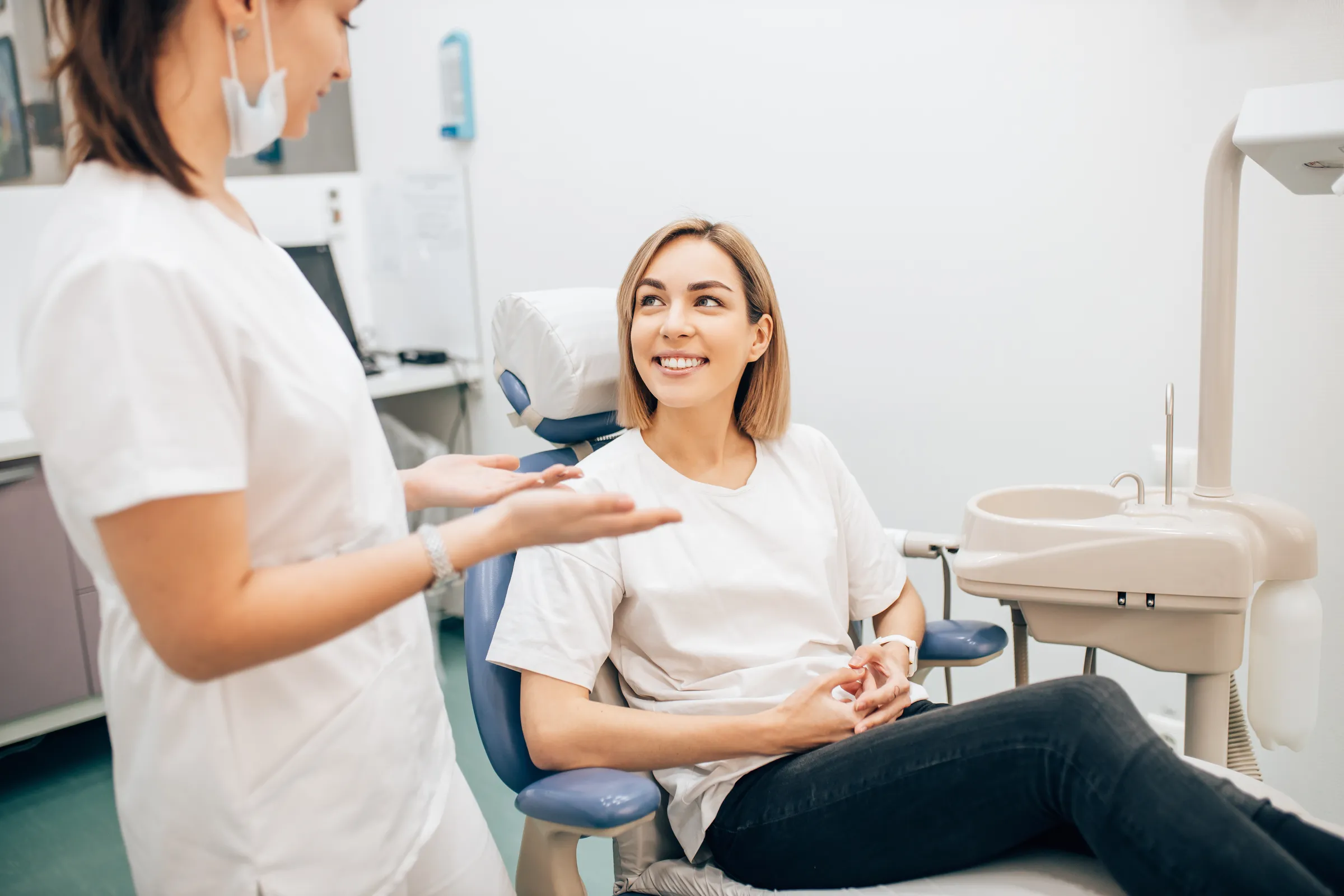 A patient and a clinician talking in a treatment room before a cleaning