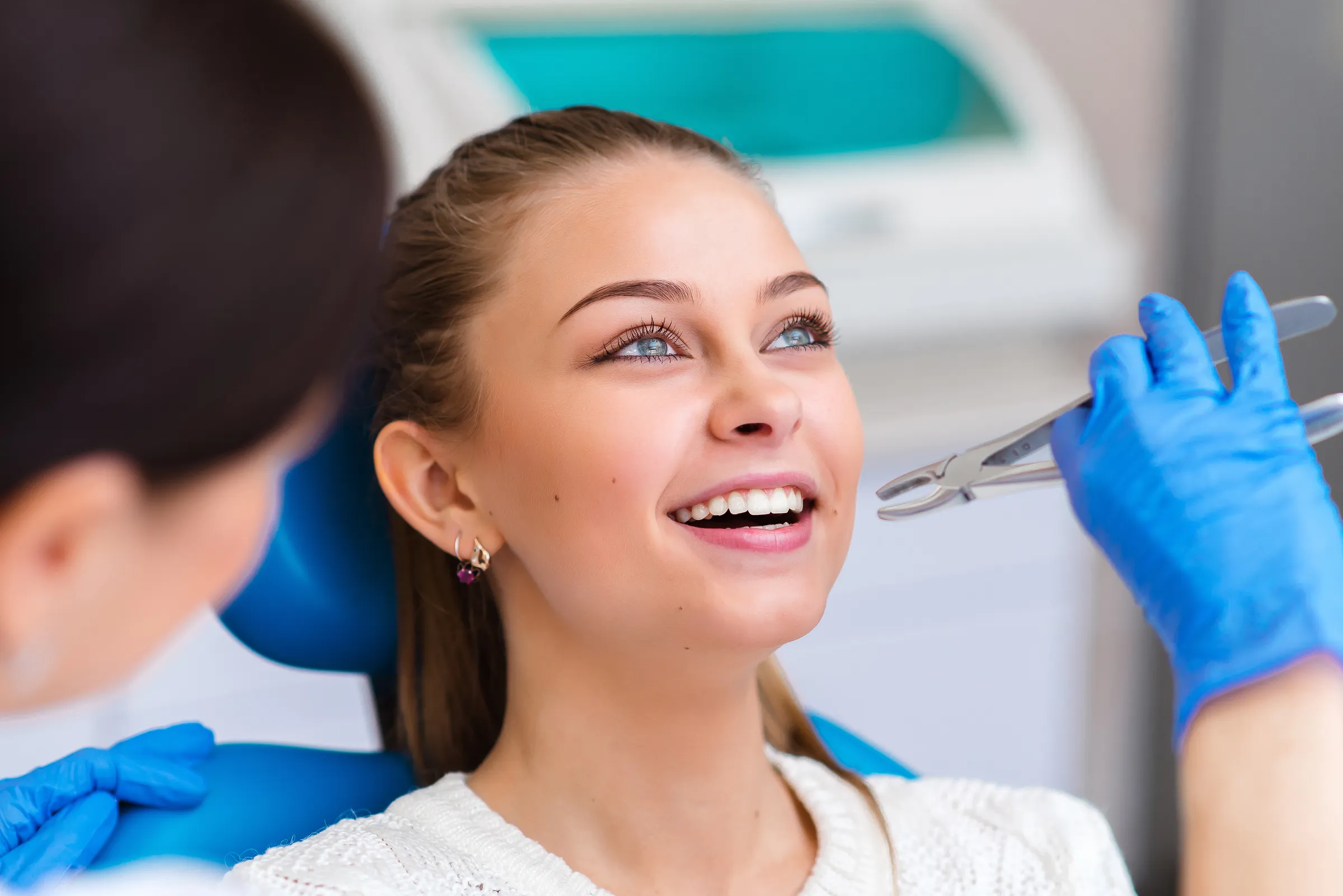 A young patient smiling in the dental chair as the team prepares to begin