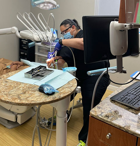A team member working at the computer beside a prepared instrument tray