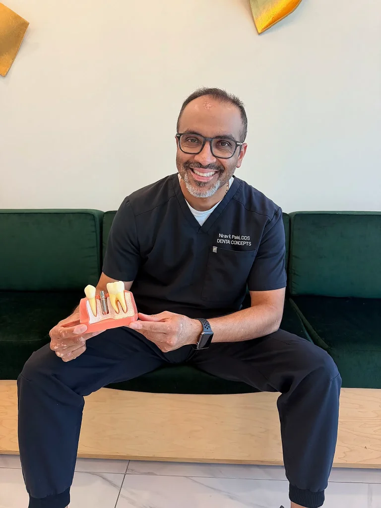 Dr. Nirav Patel with an implant model