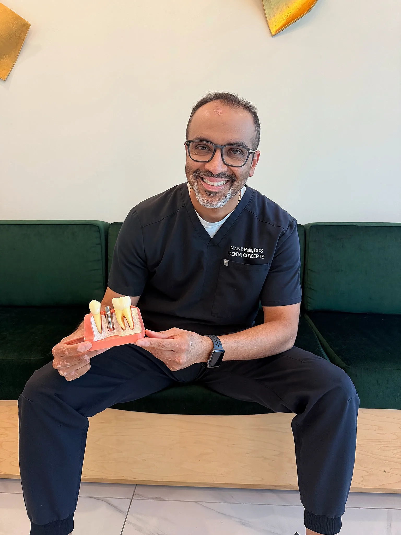 Dr. Nirav Patel with an implant model